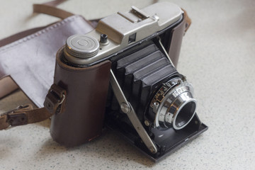 Old vintage bellows camera in a leather case