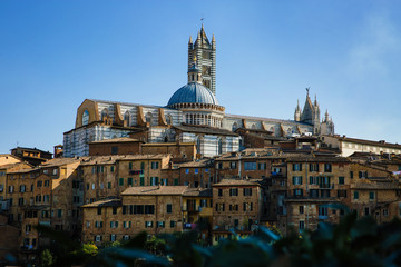 Scenic panorama of Siena, Tuscany, Italy. Scenery of beautiful ancient medieval town. View of Siena Cathedral Santa Maria Assunta (Duomo). Picturesque italian cityscape travel destination postcard.