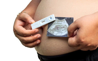 Close up of pregnant belly and holding Pregnancy test and ultrasound image. Concept of pregnancy, health care, gynecology, medicine.