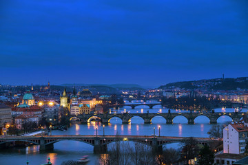 Panorama of the old part of Prague from the Letna park at dusk. Beautiful view on the bridges over the river Vltava after sunset. Old Town architecture, Czech Republic.