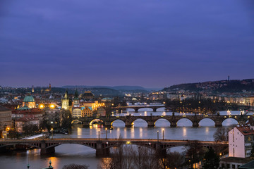 Panorama of the old part of Prague from the Letna park at dusk. Beautiful view on the bridges over the river Vltava after sunset. Old Town architecture, Czech Republic.
