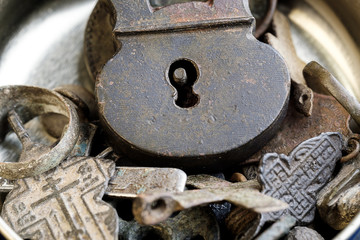 close-up of old Russian items and 18th-century coins in a metallic silver background