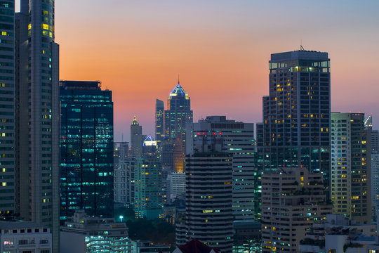 modern office buildings and condominium in Bangkok city downtown with sunset sky and clouds at Bangkok , Thailand.