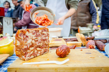 Headcheese and dry sausage on a wooden chopping board