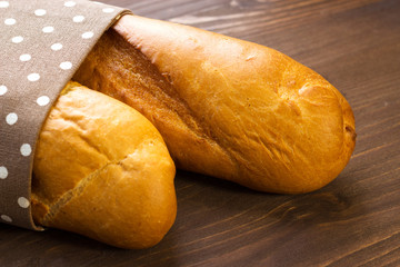 Baguette. Fresh baguette for breakfast. Baguette on the kitchen table.
