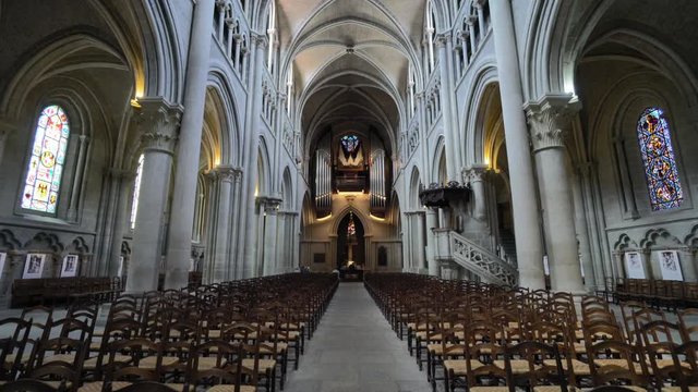 Christian religion - crossing a beautiful nave cathedral. With wooden chairs for prayers and large rib vault in the ceiling