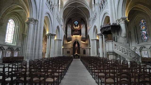 Stunning cathedral nave - gothic rib vault and wooden chairs. God worship, spirituality and religion