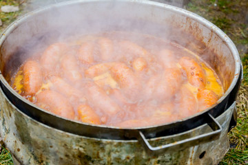Baking delicious juicy sausages on barbecue plate