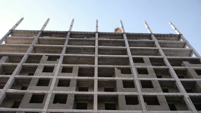 Multi-storey residential building under construction. Camera moving up.