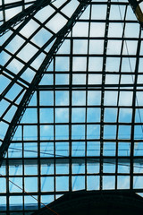 Glass ceiling overlooking the blue sky in a large shopping center and office building in a big city