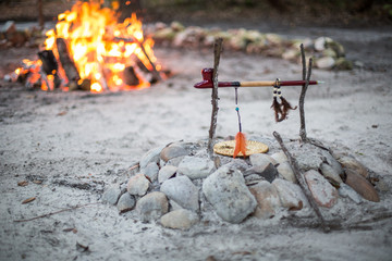 Native American Indian Wooden Smoking Pipe in Front of Fire Pit Outside