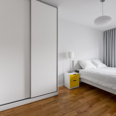 Fototapeta na wymiar White bedroom with wardrobe