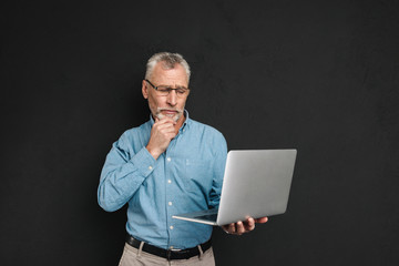 Portrait of a concentrated mature man dressed in shirt