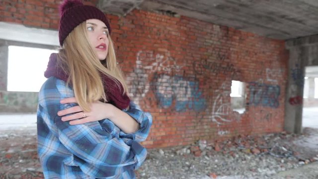 beautiful girl near a brick old wall, an abandoned building, modern art, slow-motion photography.