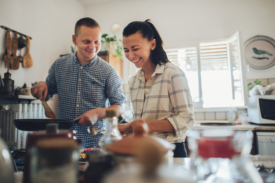 Romantic couple in love spending time together in kitchen