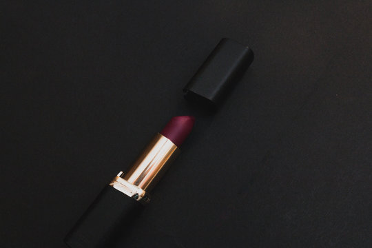 Red lipstick on black background, makeup design wallpaper