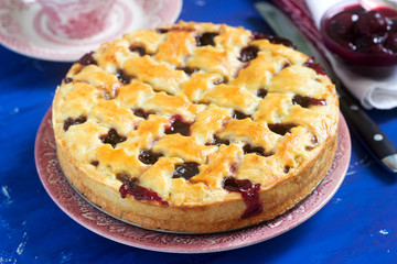 A traditional American or European cherry pie made of shortcake. Rustic style.