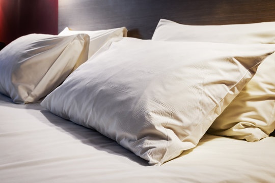 Pillows on a large king-size bed. Concept on preparation of the bed in a hotel room or at home
