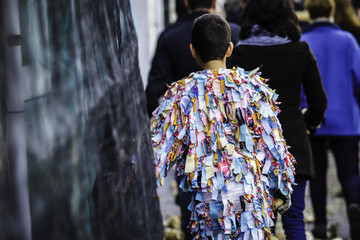 Boy costumed as Jarramplas walking to meet him at the square