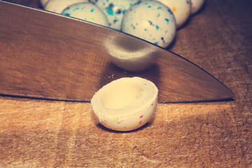 The empty white chewing gum is cut in half with a kitchen knife.