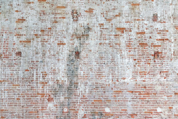 Brown brick wall behind white stucco, background, texture