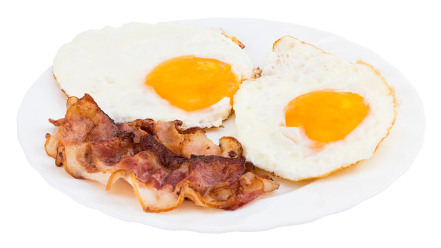 Plate With Fried Eggs And Bacon On White Background