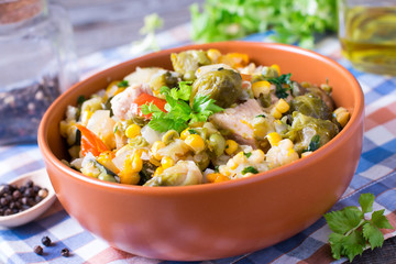 Vegetable stew. Stewed vegetables in in a plate on an old wooden table.
