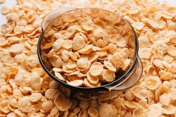 Delicious crispy cornflakes in bowl on white background, healthy breakfast
