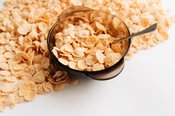 Delicious crispy cornflakes in bowl on white background, healthy breakfast