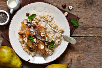 Morning breakfast. Oatmeal, caramelized pear and fried hazelnuts.