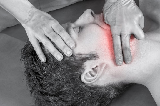 Physiotherapist, chiropractor is doing intraoral technique of massage masseter muscle. Osteopathy.