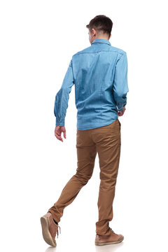 Back View Of A Walking Casual Man Looking To Side