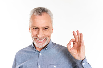 Happy man showing ok gesture and smiling isolated over white