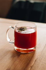Delicious fresh gaspacho in glass mug on wooden table
