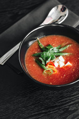Delicious tomato soup with parsley and pepper