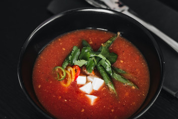 Delicious tomato soup with parsley and pepper