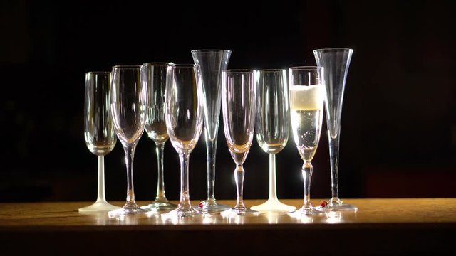Image starts blurry of champagne glasses and then goes into focus as camera pulls back and away.