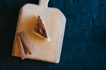 Cake on a wooden tray on a black matte background
