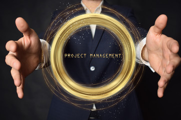 A businessman shows an inscription:PROJECT MANAGEMENT