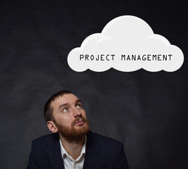 Above the businessman hangs a cloud with the inscription:PROJECT MANAGEMENT