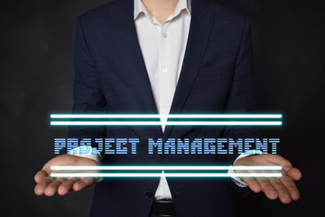 A businessman shows an inscription:PROJECT MANAGEMENT