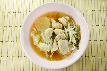 boiled rice noodles topping slice pork and ball in clear soup