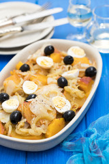 sweet potato with cod fish, onion and eggs on dish