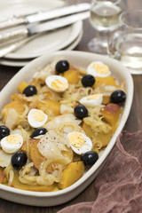 sweet potato with cod fish, onion and eggs on dish