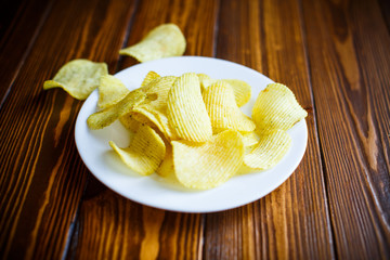 Crispy potato chips in a white plate