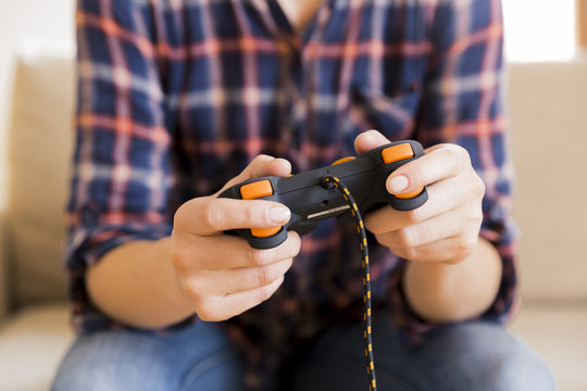 Young girl holding joystick while playing video games