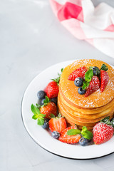 Stack of homemade pancakes for breakfast with berries