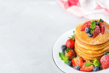 Stack of homemade pancakes for breakfast with berries
