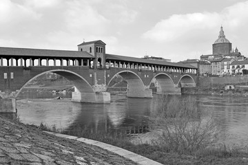 Italy - Pavia - The Covered Bridge (also called Ponte Vecchio) on the ticino with the Cathedral of...