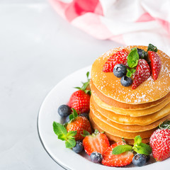 Stack of homemade pancakes for breakfast with berries